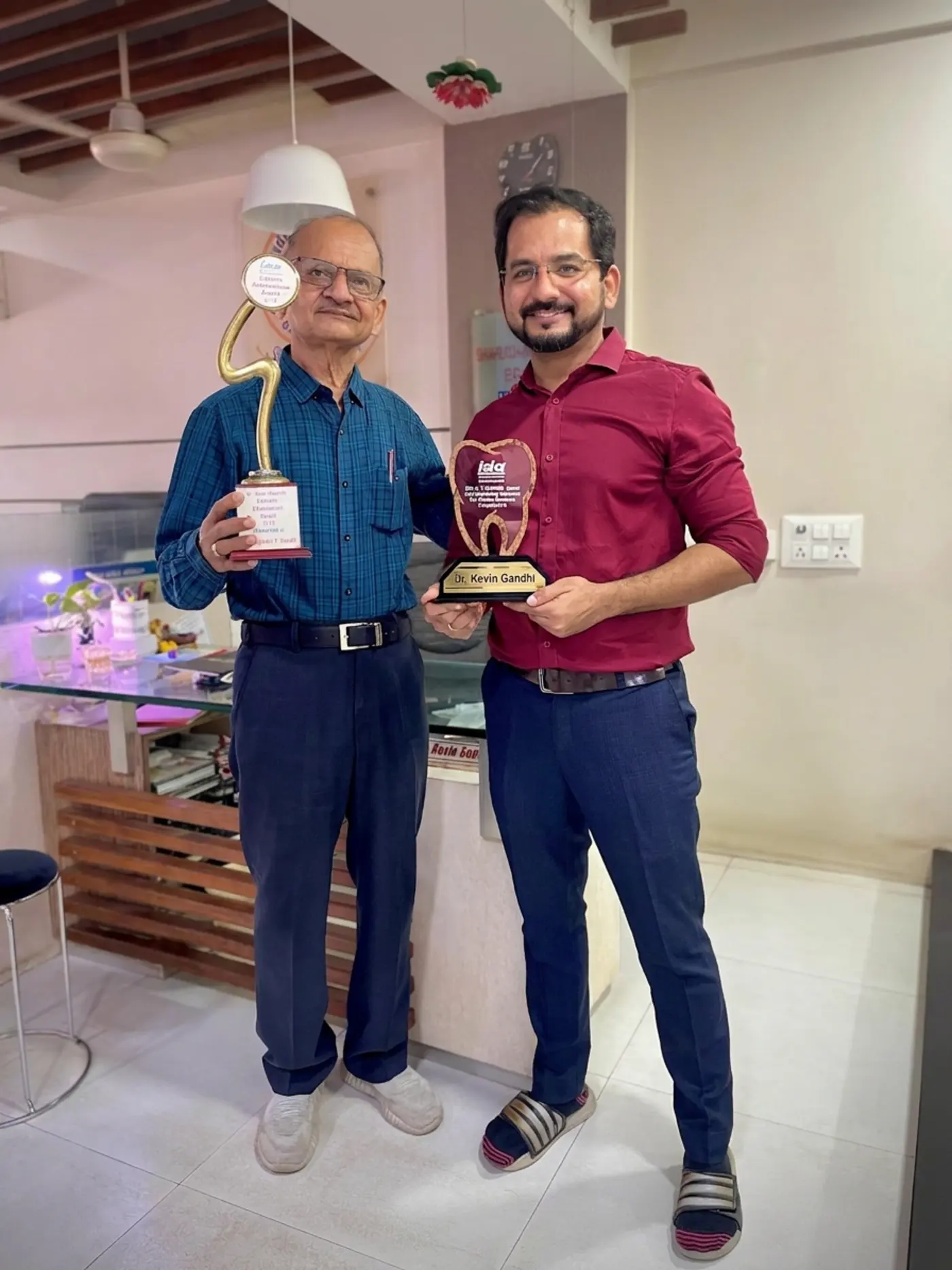 Dr. Rajendra T. Gandhi with the IDA Lifetime Achievement Award and Dr. Kevin Gandhi