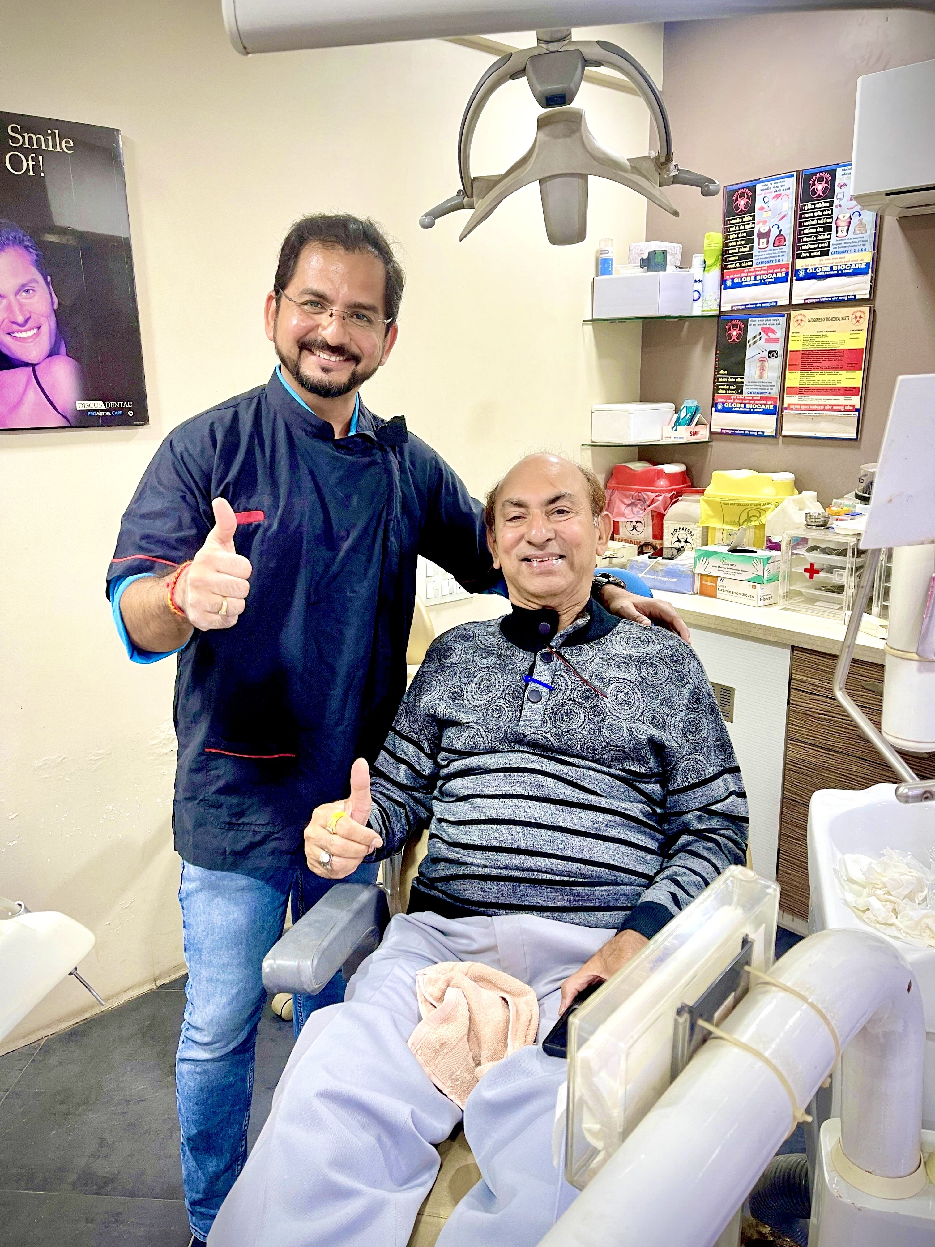Dr. Kevin Gandhi with a patient after treatment at Gandhi Dental Clinic